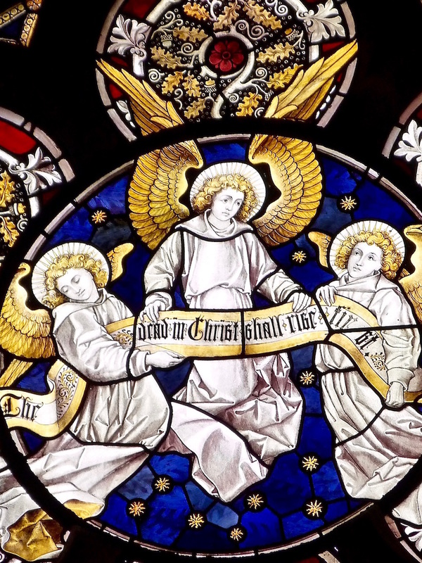 Detail of the roundel with three angels in a starry night sky in the Burlison & Grylls window in the North Aisle, 1883.